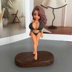 Real product photo of a personalized ChronoFig Bikini girl 3D figurine created from a photo and displayed on a wooden base.