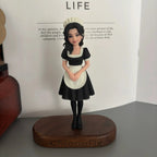 Real product photo of a personalized ChronoFig Maid 3D figurine created from a photo and displayed on a wooden base.