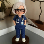 Real product photo of a personalized ChronoFig Nurse 3D figurine created from a photo and displayed on a wooden base.