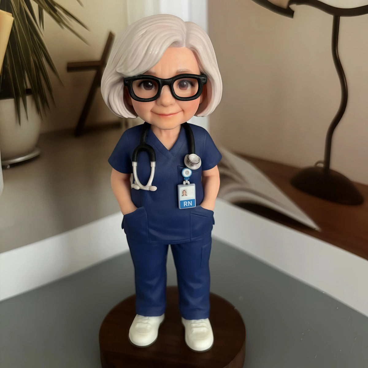 Real product photo of a personalized ChronoFig Nurse 3D figurine created from a photo and displayed on a wooden base.