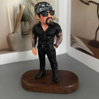Real product photo of a personalized ChronoFig Tattooed man 3D figurine created from a photo and displayed on a wooden base.