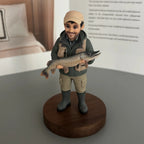 Real product photo of a personalized ChronoFig the Angler 3D figurine created from a photo and displayed on a wooden base.